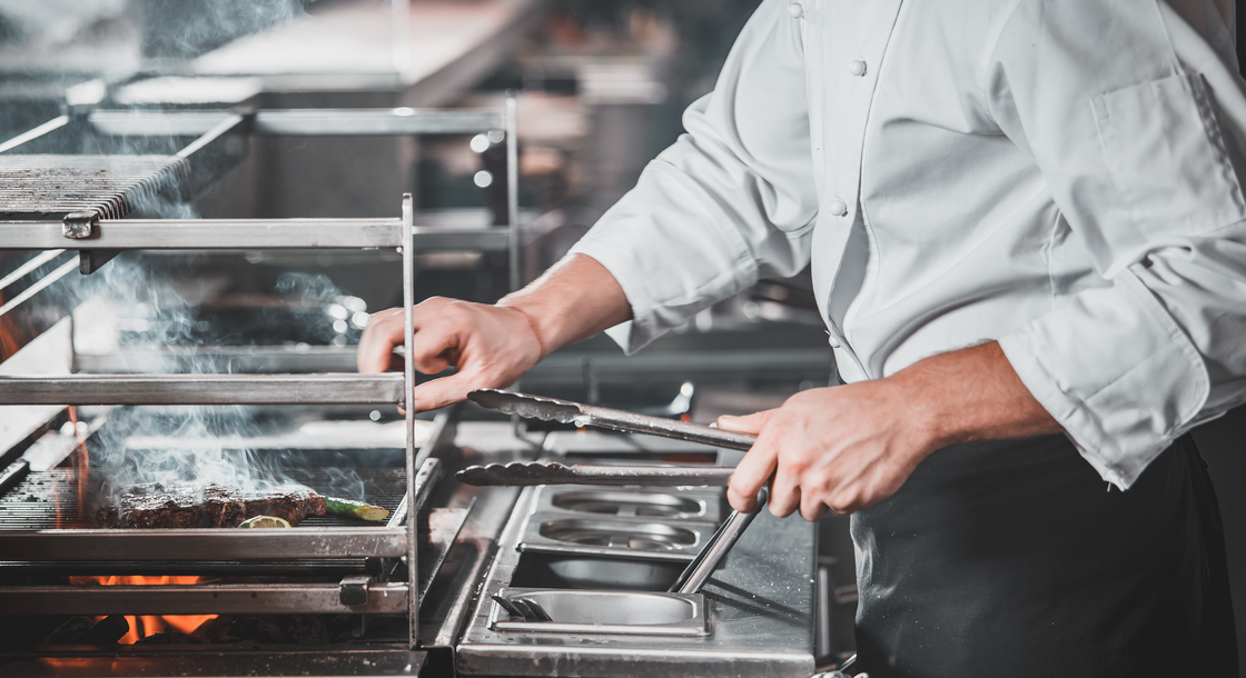 A chef prepares food in their kitchen