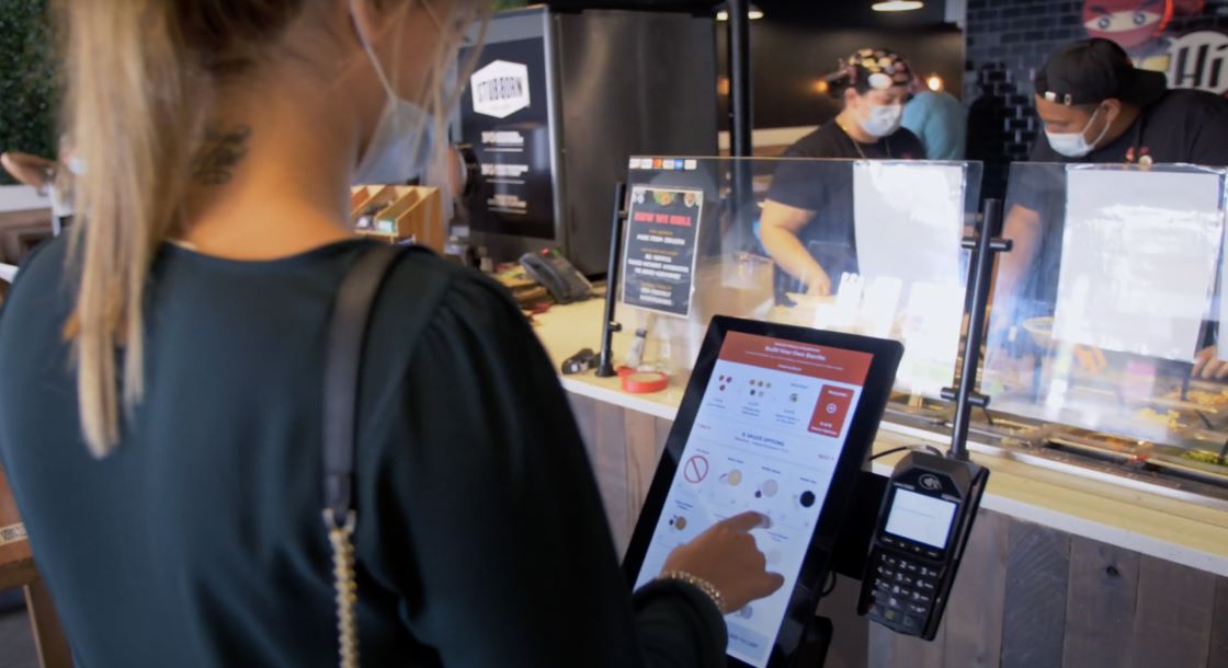woman customer using kiosk