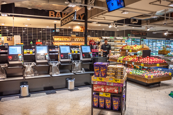 Kiosks set up at checkout inside of a grocery store