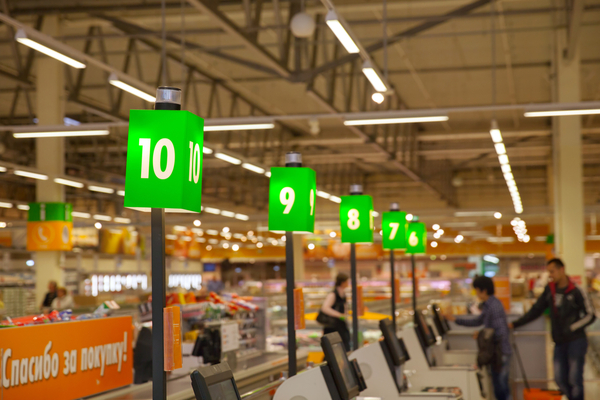 A row of checkout stations inside of a grocery store