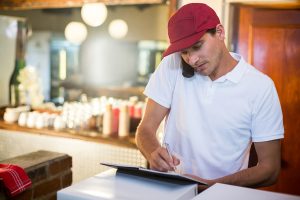 A restaurant staff member taking notes.