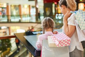 People using a kiosk at the mall.