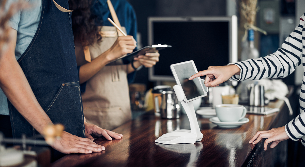 Restaurant Worker Using Handheld Mobile POS Terminal