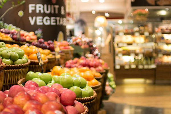 Fresh Apples In Baskets In Produce Aisle Of Grocery Store